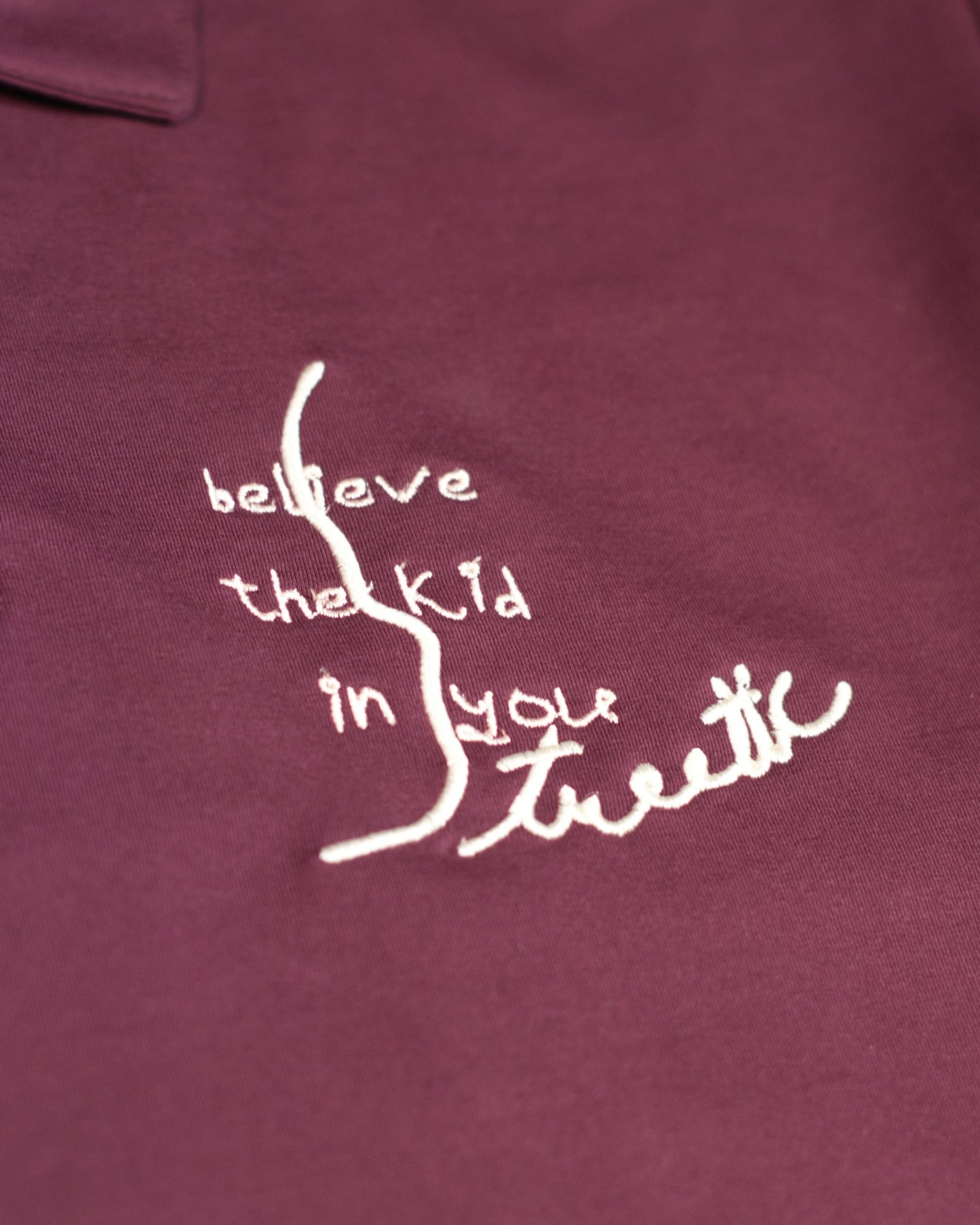 BELIEVE THE KID IN YOU EMBROIDERED WINE POLO